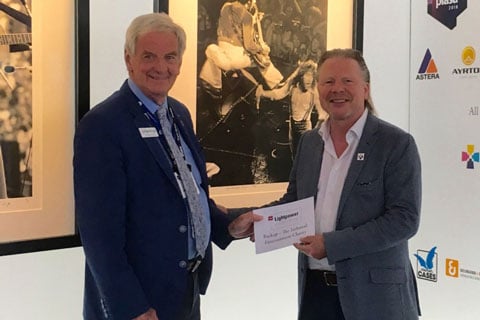 Ralph-Jörg Wezorke presents a £10,000 donation to John Simpson chairman of Backup