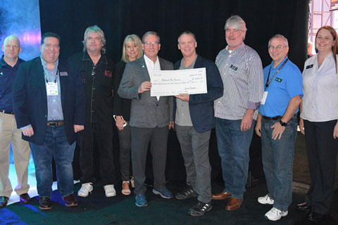 David Lincecum, vice president of marketing for ETC presents a cheque to Behind the Scene Foundation chair Rick Rudolph, joined by ETC staff and members of the Behind the Scenes Foundation Board of Directors