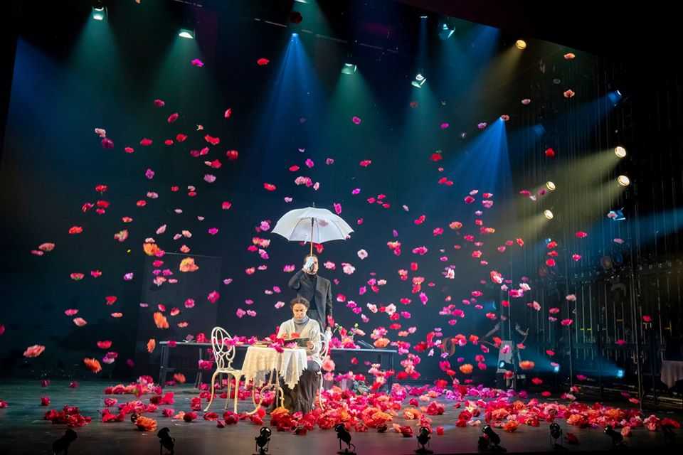 Electro Kabuki drops hundreds of flower heads to the RADA Jerwood Vanbrugh stage to mark a scene change in a performance of The Importance of Being Earnest.