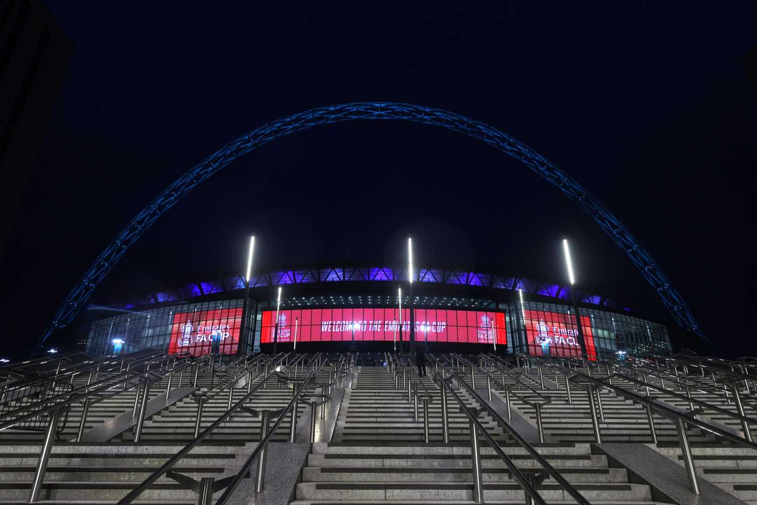 The giant LED screens dominate the stadium entrance