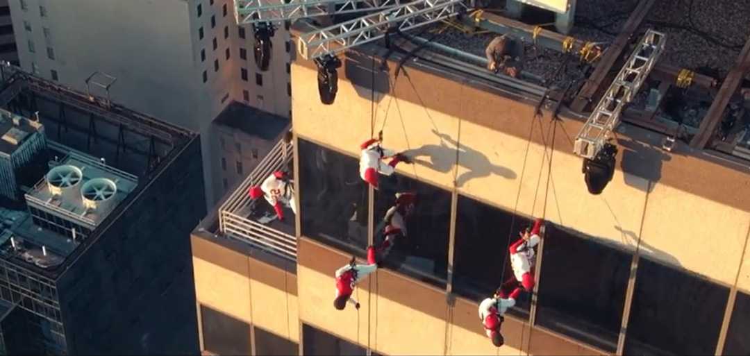 A vertical dance troupe performed across the façade of the building