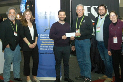 Westview president Eric Bloom presents a cheque to Eddie Raymond, surrounded by Westview team members and BTS board members