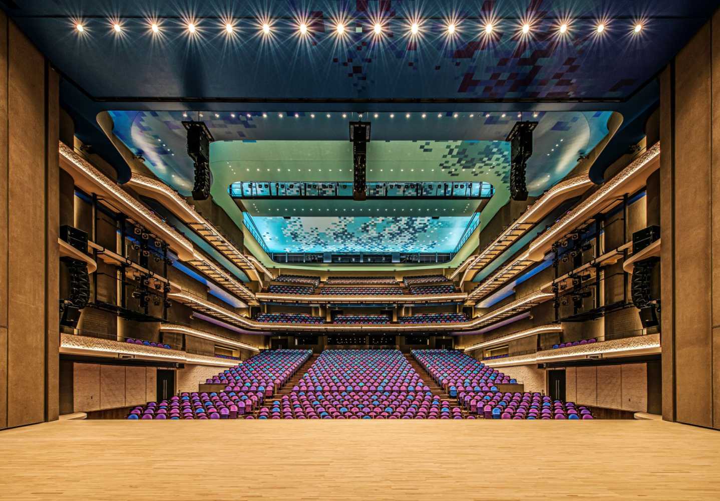 Geo M10 line arrays with MSUB15 subs are flown left, central, and right above the stage in the large theatre