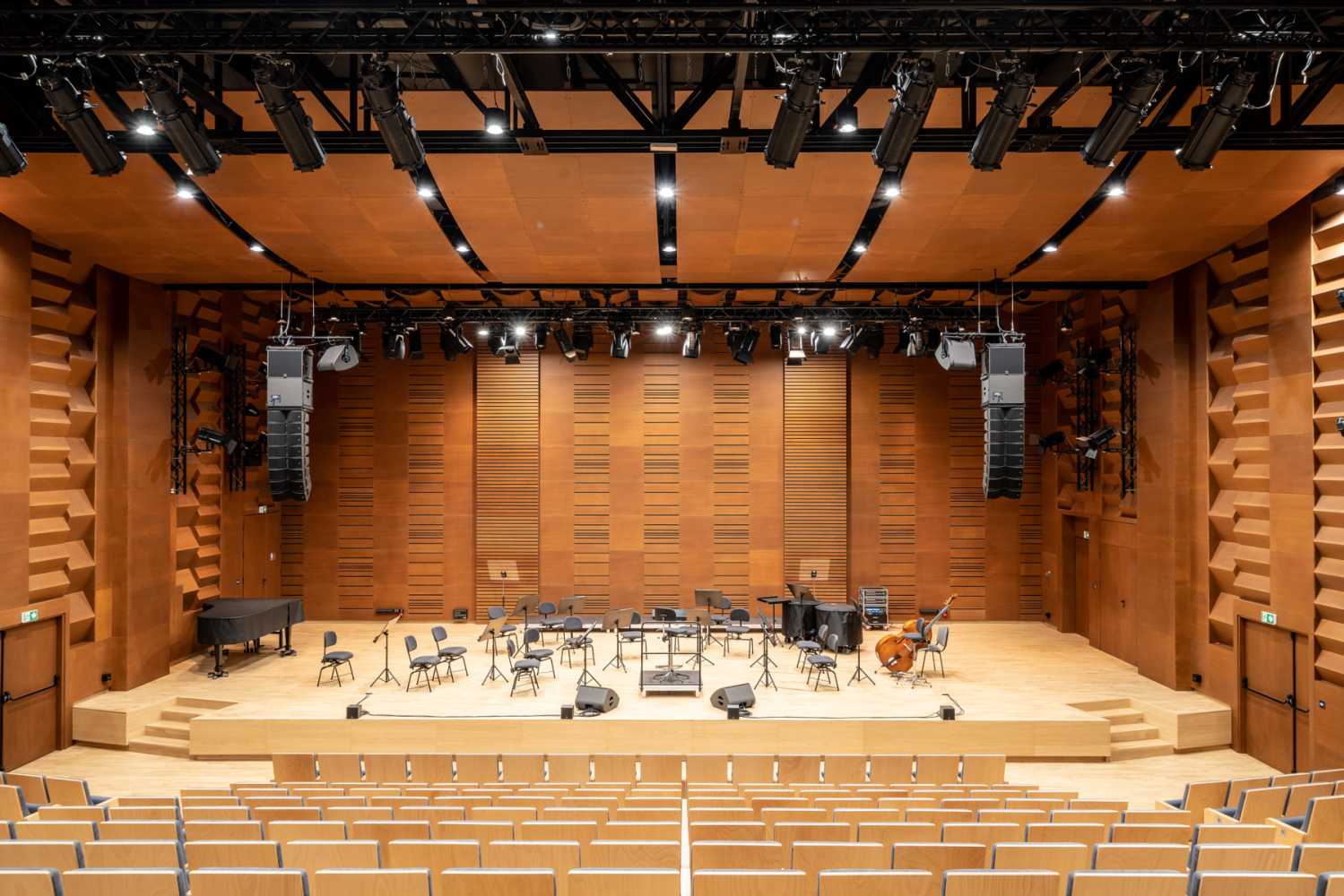 The venue comprises a concert hall, foyer, sound booth, and recording studio